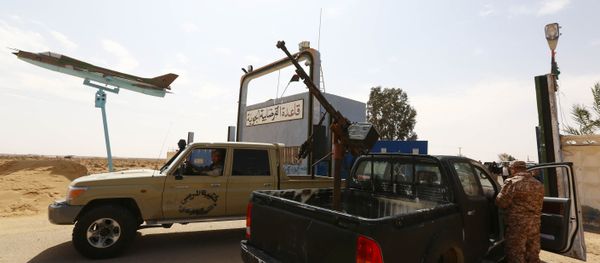 Members of forces loyal to Libya's Islamist-backed parliament General National Congress (GNC) secure the Al-Ghardabiya airbase as they fight Islamic State (IS) group jihadists on the outskirts of Libya's western city of Sirte on March 16, 2015 Members of forces loyal to Libya's Islamist-backed parliament General National Congress (GNC) secure the Al-Ghardabiya airbase as they fight Islamic State (IS) group jihadists on the outskirts of Libya's western city of Sirte on March 16, 2015 - Sputnik International