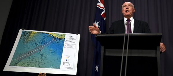Australia's Deputy Prime Minister Warren Truss speaks during a media conference next to a map displaying the search area for missing Malaysia Airlines Flight MH370 at Parliament House in Canberra, Australia, December 3, 2015 Australia's Deputy Prime Minister Warren Truss speaks during a media conference next to a map displaying the search area for missing Malaysia Airlines Flight MH370 at Parliament House in Canberra, Australia, December 3, 2015 - Sputnik International