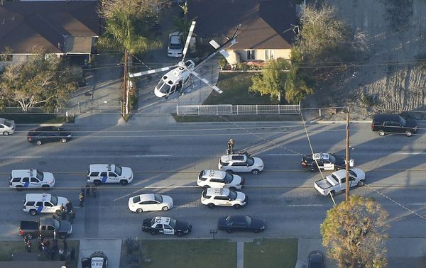 A police helicopter flies over emergency vehicles during a manhunt which followed a mass shooting in San Bernardino, California December 2, 2015 A police helicopter flies over emergency vehicles during a manhunt which followed a mass shooting in San Bernardino, California December 2, 2015 - Sputnik International