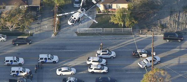 A police helicopter flies over emergency vehicles during a manhunt which followed a mass shooting in San Bernardino, California December 2, 2015 A police helicopter flies over emergency vehicles during a manhunt which followed a mass shooting in San Bernardino, California December 2, 2015 - Sputnik International