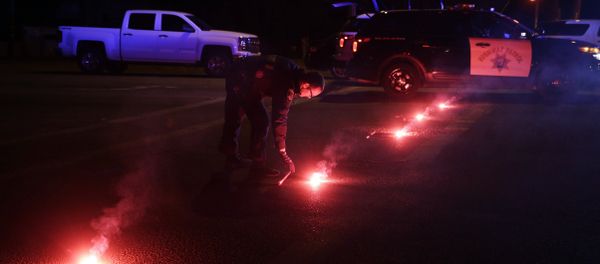A police officer lights up flares near the scene where a shootout took place, Wednesday, Dec. 2, 2015, in San Bernardino, Calif. A police officer lights up flares near the scene where a shootout took place, Wednesday, Dec. 2, 2015, in San Bernardino, Calif. - Sputnik International