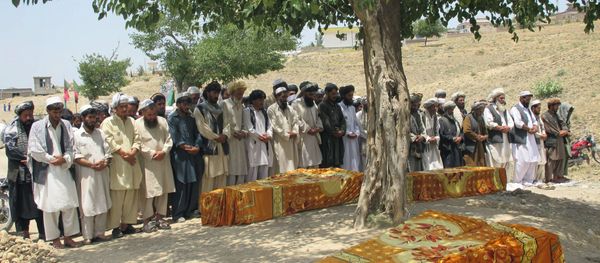 Afghans offer prayers over the covered coffins during a burial ceremony in Khost, Afghanistan. - Sputnik International