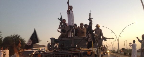 Fighters of the al-Qaida-inspired Islamic State of Iraq and the Levant (ISIL) parade in a commandeered Iraqi security forces armored vehicle down a main road at the northern city of Mosul, Iraq. (File) - Sputnik International