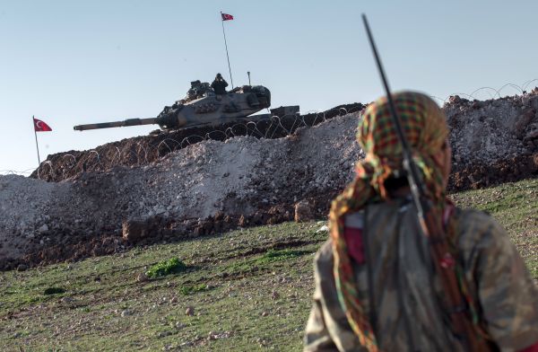 A Syrian Kurdish militia member of YPG patrols near a Turkish army tank as Turks work to build a new Ottoman tomb in the background in Esme village in Aleppo province, Syria. (File) A Syrian Kurdish militia member of YPG patrols near a Turkish army tank as Turks work to build a new Ottoman tomb in the background in Esme village in Aleppo province, Syria. (File) - Sputnik International