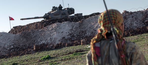 A Syrian Kurdish militia member of YPG patrols near a Turkish army tank as Turks work to build a new Ottoman tomb in the background in Esme village in Aleppo province, Syria. (File) A Syrian Kurdish militia member of YPG patrols near a Turkish army tank as Turks work to build a new Ottoman tomb in the background in Esme village in Aleppo province, Syria. (File) - Sputnik International