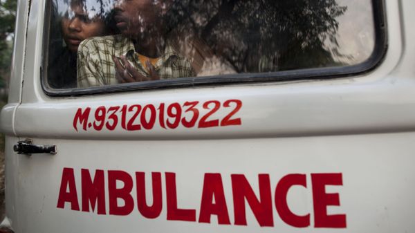 Relatives look out through an ambulance window as they take for burial the body of a man who died in the collapse of a four-story apartment building in New Delhi, India, Tuesday, Nov. 16, 2010 - Sputnik International