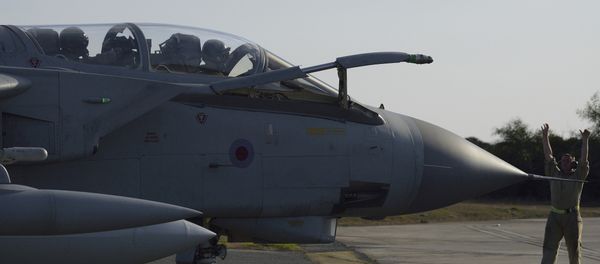A ground crewman directs a Royal Air Force Tornado along the tarmac of a British air base in Akrotiri, Cyprus, after returning from an airstrike against Islamic State group targets in Syria Thursday, Dec. 3, 2015 - Sputnik International