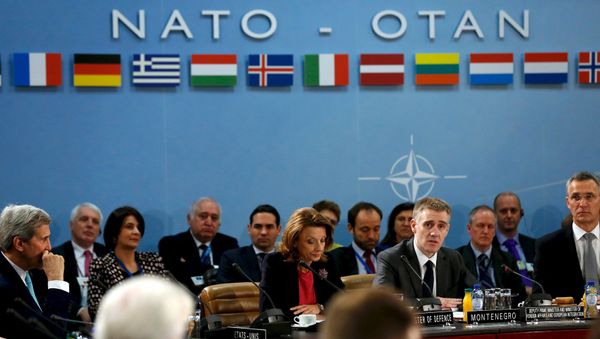 Montenegro's Foreign Minister Igor Luksic (at table, 2nd R) delivers remarks with Defense Minister Milica Pejanovic (3rd R) after Montenegro was welcomed as a new member at the NATO ministerial meetings at the NATO headquarters in Brussels December 2, 2015 Montenegro's Foreign Minister Igor Luksic (at table, 2nd R) delivers remarks with Defense Minister Milica Pejanovic (3rd R) after Montenegro was welcomed as a new member at the NATO ministerial meetings at the NATO headquarters in Brussels December 2, 2015 - Sputnik International