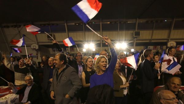 Supporters of far right National Front party regional leader for southeastern France, Marion Marechal-Le Pen, wave flags at a meeting after the results of the first round of the regional elections, in Carpentras, southern France Supporters of far right National Front party regional leader for southeastern France, Marion Marechal-Le Pen, wave flags at a meeting after the results of the first round of the regional elections, in Carpentras, southern France - Sputnik International