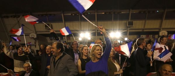 Supporters of far right National Front party regional leader for southeastern France, Marion Marechal-Le Pen, wave flags at a meeting after the results of the first round of the regional elections, in Carpentras, southern France Supporters of far right National Front party regional leader for southeastern France, Marion Marechal-Le Pen, wave flags at a meeting after the results of the first round of the regional elections, in Carpentras, southern France - Sputnik International