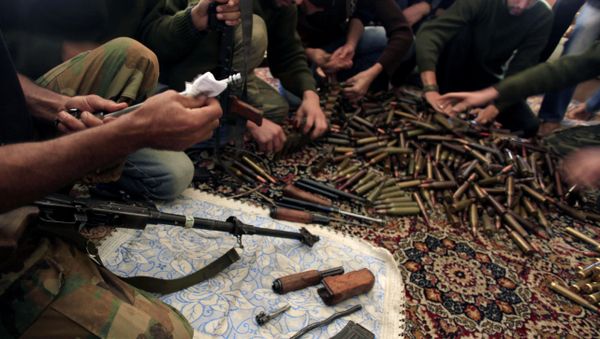 Free Syrian Army fighters clean their weapons and check ammunition at their base on the outskirts of Aleppo, Syria. - Sputnik International