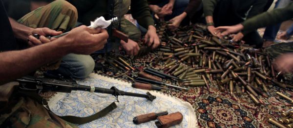 Free Syrian Army fighters clean their weapons and check ammunition at their base on the outskirts of Aleppo, Syria. - Sputnik International