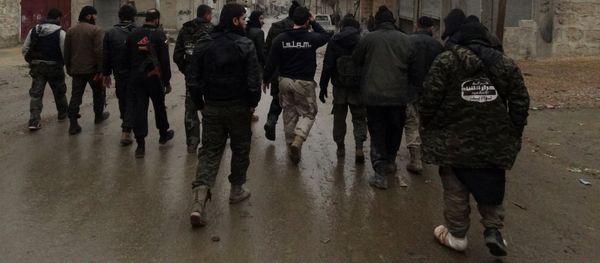 Opposition fighters from the Ahrar Al-Sham brigade, part of the Islamic front coalition, walk in the Shiekh Lutfi neighbourhood of the northern Syrian city of Aleppo during ongoing clashes with government forces on January 27, 2014 Opposition fighters from the Ahrar Al-Sham brigade, part of the Islamic front coalition, walk in the Shiekh Lutfi neighbourhood of the northern Syrian city of Aleppo during ongoing clashes with government forces on January 27, 2014 - Sputnik International