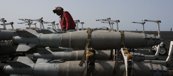 A U.S. sailor works with bombs being prepared for loading on military jets on the flight deck of the USS Carl Vinson aircraft carrier in the Persian Gulf, Thursday, March 19, 2015 A U.S. sailor works with bombs being prepared for loading on military jets on the flight deck of the USS Carl Vinson aircraft carrier in the Persian Gulf, Thursday, March 19, 2015 - Sputnik International