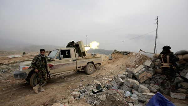 Kurdish peshmerga fighter fires a weapon towards positions of the Islamic State group who are 500 meters or half a mile away, overlooking the strategic town of Sinjar, northern Iraq - Sputnik International