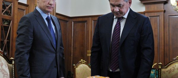 Russian Defense Minister Sergei Shoigu shows President Vladimir Putin a flight recorder of a Russian warplane shot down by a Turkish jet on Nov. 24. - Sputnik International