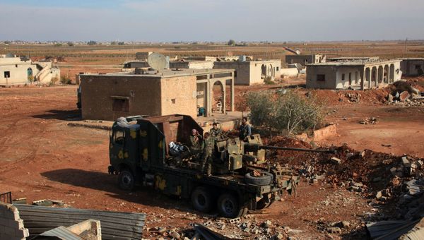 Syrian government fighters stand on a vehicle carrying heavy artillery  in the village of Akoula near the airport of Kweyris, in the northern Syrian province of Aleppo, after they re-took the area from the control of the Islamic State (IS) group (File) - Sputnik International