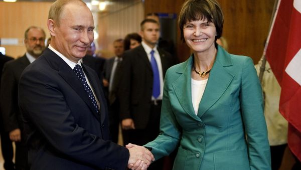 Russian Prime Minister Vladimir Putin (L) shakes hands to Swiss President Micheline Calmy-Rey prior to bilateral talks on the sideline of the 100th annual conference of the International Labor Organization (ILO) at the United Nations Offices on June 15, 2011 in Geneva Russian Prime Minister Vladimir Putin (L) shakes hands to Swiss President Micheline Calmy-Rey prior to bilateral talks on the sideline of the 100th annual conference of the International Labor Organization (ILO) at the United Nations Offices on June 15, 2011 in Geneva - Sputnik International
