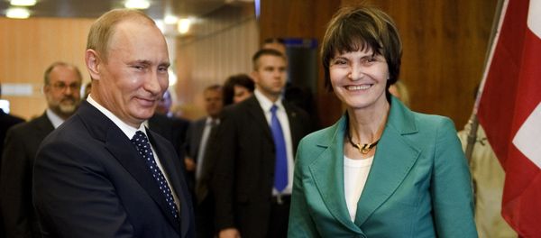 Russian Prime Minister Vladimir Putin (L) shakes hands to Swiss President Micheline Calmy-Rey prior to bilateral talks on the sideline of the 100th annual conference of the International Labor Organization (ILO) at the United Nations Offices on June 15, 2011 in Geneva - Sputnik International