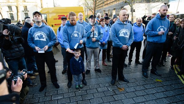 British military veterans (2L-R) Phil Mace, Kirk Sollitt and David Lenham discard their service medals on the pavement outside Downing Street in central London on December 8, 2015. - Sputnik International