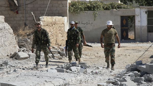 Syrian army soldiers walk in Achan, Hama province, Syria Syrian army soldiers walk in Achan, Hama province, Syria - Sputnik International