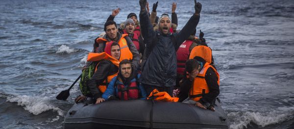 Migrants and refugees react as they arrive on a dinghy from the Turkish coast to the northeastern Greek island of Lesbos on Wednesday, Dec. 9, 2015. Migrants and refugees react as they arrive on a dinghy from the Turkish coast to the northeastern Greek island of Lesbos on Wednesday, Dec. 9, 2015. - Sputnik International