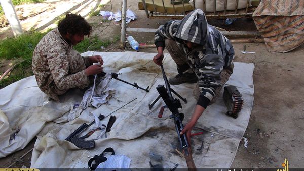 In this file photo released on June 16, 2015, by Ismamic State militant group supporters on an anonymous photo sharing website, Islamic State militants clean their weapons in Deir el-Zour city, Syria In this file photo released on June 16, 2015, by Ismamic State militant group supporters on an anonymous photo sharing website, Islamic State militants clean their weapons in Deir el-Zour city, Syria - Sputnik International