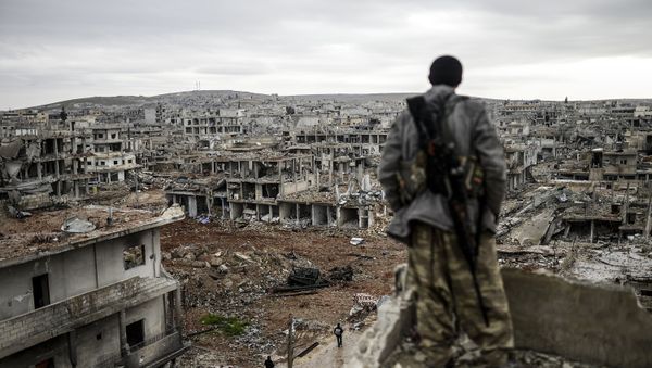 Musa, a 25-year-old Kurdish marksman, stands atop a building as he looks at the destroyed Syrian town of Kobane, also known as Ain al-Arab, on January 30, 2015 Musa, a 25-year-old Kurdish marksman, stands atop a building as he looks at the destroyed Syrian town of Kobane, also known as Ain al-Arab, on January 30, 2015 - Sputnik International