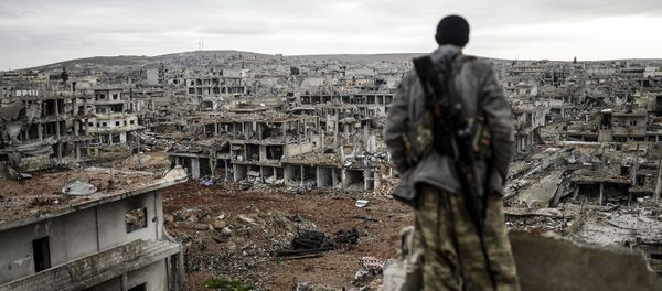 Musa, a 25-year-old Kurdish marksman, stands atop a building as he looks at the destroyed Syrian town of Kobane, also known as Ain al-Arab, on January 30, 2015 Musa, a 25-year-old Kurdish marksman, stands atop a building as he looks at the destroyed Syrian town of Kobane, also known as Ain al-Arab, on January 30, 2015 - Sputnik International