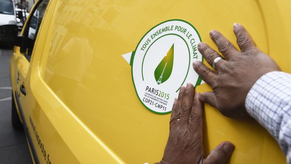 A man puts a sticker of the COP21 on a van of the French postal service, La Poste, on October 30, 2015 in Paris, ahead of the Climate Change Conference 2015. The COP21, organized by the French government will run from November 30 to December 11, 2015 A man puts a sticker of the COP21 on a van of the French postal service, La Poste, on October 30, 2015 in Paris, ahead of the Climate Change Conference 2015. The COP21, organized by the French government will run from November 30 to December 11, 2015 - Sputnik International