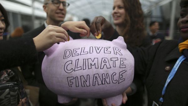 Participants contribute coins into a piggy bank during the World Climate Change Conference 2015 (COP21) at Le Bourget, near Paris, France, December 10, 2015 Participants contribute coins into a piggy bank during the World Climate Change Conference 2015 (COP21) at Le Bourget, near Paris, France, December 10, 2015 - Sputnik International