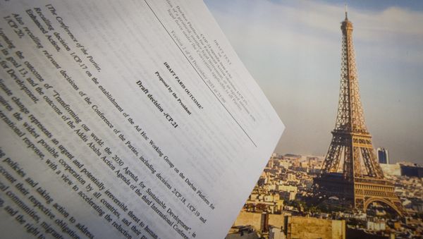 An illustration picture taken on December 10, 2015 in Paris shows a draft for the outcome of the COP21 United Nations conference on climate change next to a picture of the Eiffel Tower - Sputnik International