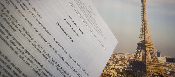 An illustration picture taken on December 10, 2015 in Paris shows a draft for the outcome of the COP21 United Nations conference on climate change next to a picture of the Eiffel Tower - Sputnik International