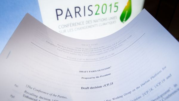 An illustration picture taken on December 10, 2015 in Paris shows a draft for the outcome of the COP21 United Nations conference on climate change next to the logo of the summit - Sputnik International