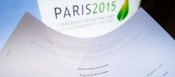 An illustration picture taken on December 10, 2015 in Paris shows a draft for the outcome of the COP21 United Nations conference on climate change next to the logo of the summit - Sputnik International
