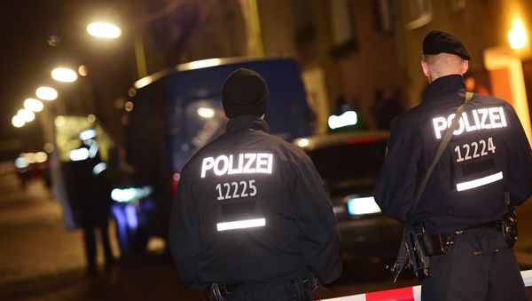 Armed police stand guard as others search a van at the scene in the Karl-Elsasser Street in Berlin's southern suburb of Britz on November 26, 2015. German police detained two suspects in a series of raids targeting Islamists in Berlin and said they were examining a suspicious object Armed police stand guard as others search a van at the scene in the Karl-Elsasser Street in Berlin's southern suburb of Britz on November 26, 2015. German police detained two suspects in a series of raids targeting Islamists in Berlin and said they were examining a suspicious object - Sputnik International