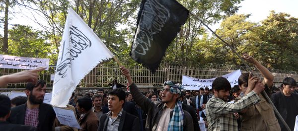 In this Saturday, Oct. 25, 2014 photo, Afghan university students wave a black flag used by the Islamic State group and a white flag used by Taliban during its 1996-2001 rule of Afghanistan at a demonstration in Kabul, Afghanistan In this Saturday, Oct. 25, 2014 photo, Afghan university students wave a black flag used by the Islamic State group and a white flag used by Taliban during its 1996-2001 rule of Afghanistan at a demonstration in Kabul, Afghanistan - Sputnik International