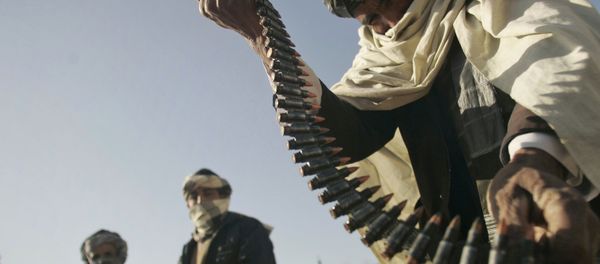 FILE - In this Dec. 28, 2011 file photo, a former Taliban fighter places a range of bullets before surrendering it to Afghan authorities, as part of a peace-reconciliation program in Herat, west of Kabul, Afghanistan FILE - In this Dec. 28, 2011 file photo, a former Taliban fighter places a range of bullets before surrendering it to Afghan authorities, as part of a peace-reconciliation program in Herat, west of Kabul, Afghanistan - Sputnik International