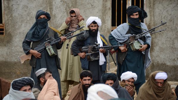 In this Tuesday, Nov. 3, 2015 photo, Afghan Taliban fighters listen to Mullah Mohammed Rasool, unseen, the newly-elected leader of a breakaway faction of the Taliban, in Farah province, Afghanistan - Sputnik International