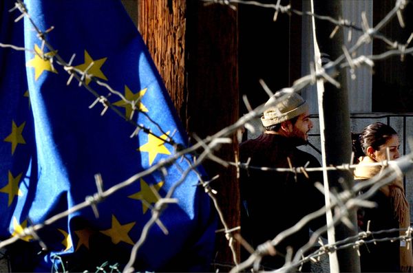 Turkish Cypriot couple, seen behind barbed wire and an EU flag, as they cross the Ledra Palace checkpoint in Nicosia, Cyprus. Turkish Cypriot couple, seen behind barbed wire and an EU flag, as they cross the Ledra Palace checkpoint in Nicosia, Cyprus. - Sputnik International