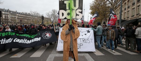 A protestor dressed in reference to Star Wars stands before a banner reading Defend the climate and democracy, you must during a rally against global warming on November 29, 2015 in Paris, a day ahead of the start of UN conference on climate change COP21 A protestor dressed in reference to Star Wars stands before a banner reading Defend the climate and democracy, you must during a rally against global warming on November 29, 2015 in Paris, a day ahead of the start of UN conference on climate change COP21 - Sputnik International