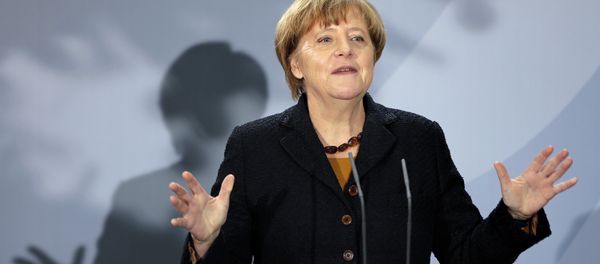 German Chancellor Angela Merkel delivers a speech during a reception at the chancellery in Berlin, Germany, Monday, Dec. 7, 2015 to mark the 60th. anniversary of the arrival of the first migrant workers in Germany. Slogan reads 'in Germany'. - Sputnik International