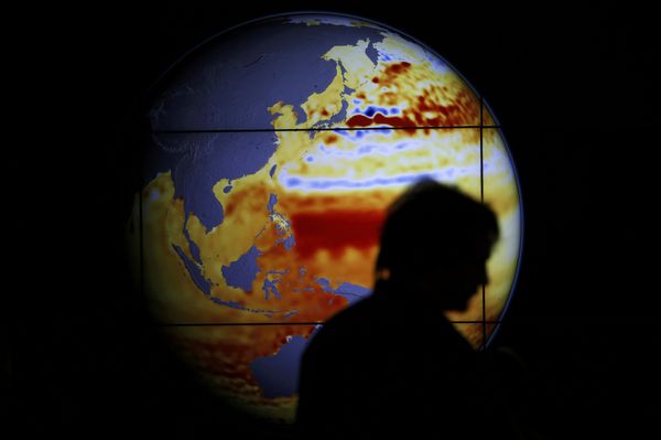 A woman walks past a map showing the elevation of the sea in the last 22 years during the World Climate Change Conference 2015 (COP21) at Le Bourget, near Paris, France, December 11, 2015 - Sputnik International