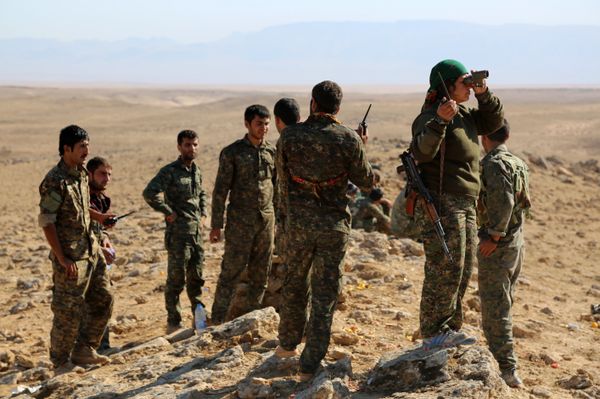A group of coalition forces, which includes People's Protection Units (YPG) Women's Protection Units (YPJ), Sutoro militia, a pro-government Syriac Christian movement, and other forces, monitor the area in al-Hol in the Syrian Hasakeh province, some 650 kms northeast of Damascus, near the Iraqi border on November 2, 2015 - Sputnik International