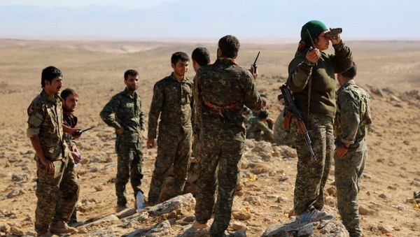 A group of coalition forces, which includes People's Protection Units (YPG) Women's Protection Units (YPJ), Sutoro militia, a pro-government Syriac Christian movement, and other forces, monitor the area in al-Hol in the Syrian Hasakeh province, some 650 kms northeast of Damascus, near the Iraqi border on November 2, 2015 A group of coalition forces, which includes People's Protection Units (YPG) Women's Protection Units (YPJ), Sutoro militia, a pro-government Syriac Christian movement, and other forces, monitor the area in al-Hol in the Syrian Hasakeh province, some 650 kms northeast of Damascus, near the Iraqi border on November 2, 2015 - Sputnik International