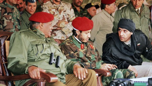 In this undated file photo made available Sunday, Sept. 25, 2011, al-Saadi Gadhafi, center, and Hannibal Gadhafi, right, sons of Libyan leader Moammar Gadhafi, are seen in the audience at a military exercise by the elite military unit commanded by their brother, Khamis, in Zlitan - 90 miles (140 kilometers) southeast of Tripoli, Libya. - Sputnik International