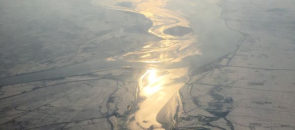 In this Friday, Nov. 27, 2015, photo, which was taken from an airplane approaching Pyongyang, light from the evening sun is cast on a river flowing through snow covered farm fields in North Korea In this Friday, Nov. 27, 2015, photo, which was taken from an airplane approaching Pyongyang, light from the evening sun is cast on a river flowing through snow covered farm fields in North Korea - Sputnik International