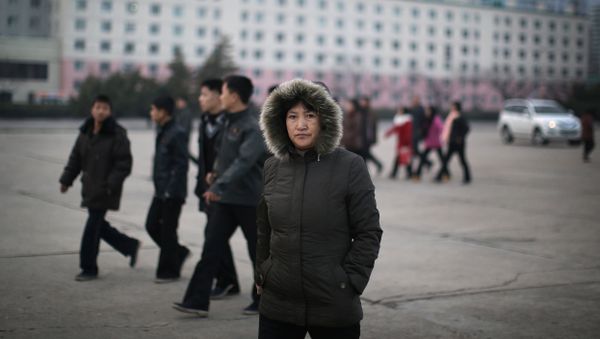 A North Korean woman walks down the streets of Pyongyang, North Korea on Tuesday, Dec. 1, 2015 where the winter season has started A North Korean woman walks down the streets of Pyongyang, North Korea on Tuesday, Dec. 1, 2015 where the winter season has started - Sputnik International