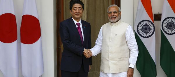 Japan's Prime Minister Shinzo Abe (L) shakes hands with his Indian counterpart Narendra Modi during a photo opportunity ahead of their meeting at Hyderabad House in New Delhi December 12, 2015 - Sputnik International