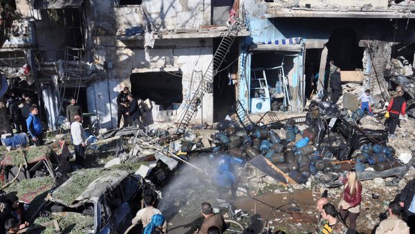 Syrians gather at the site of a car bomb explosion in al-Zahra neighborhood in Homs - Sputnik International